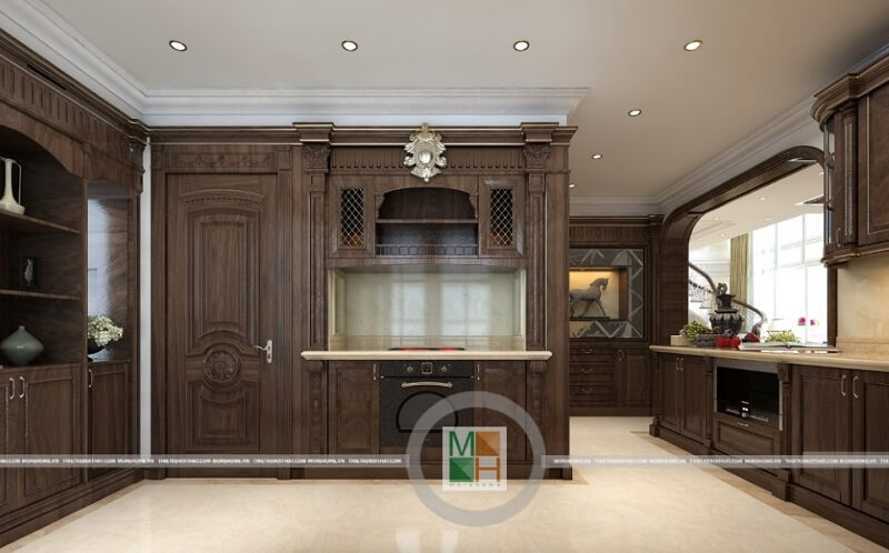 Thiết kế nội thất phòng bếp chung cư tân cổ điển với hệ tủ bếp gỗ tự nhiên màu nâu trầm mang đến vẻ đẹp sang trọng, đẳng cấp cho căn phòng. Nội thất phòng bếp
